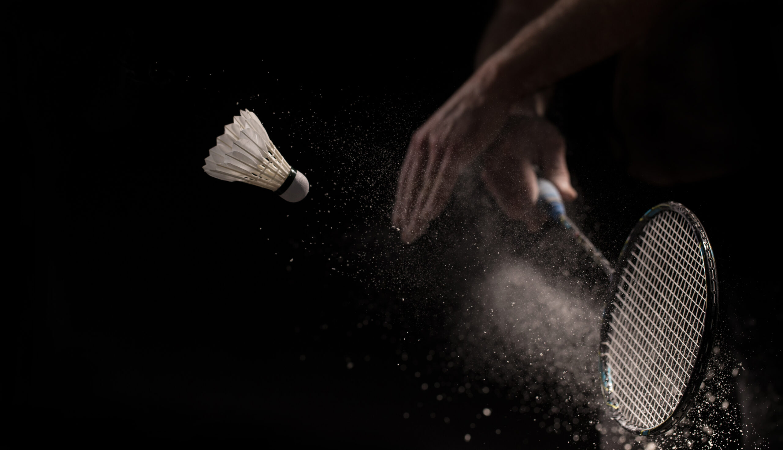 Badminton racket and shuttlecock in motion , shuttlecock sport